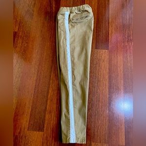 Casual yet stylish khaki pants with white tuxedo stripe down the side.